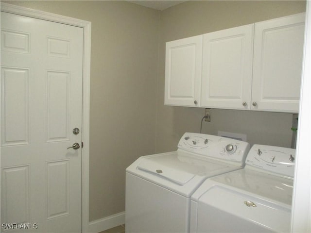 laundry room featuring cabinets and washing machine and dryer