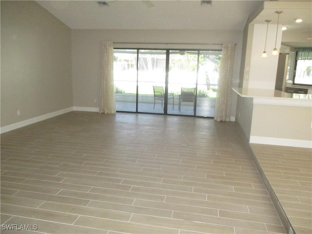 unfurnished room with hardwood / wood-style flooring and plenty of natural light