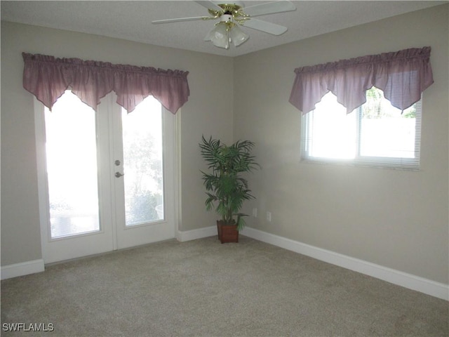 empty room with ceiling fan and light colored carpet