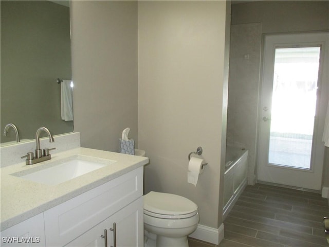 bathroom with vanity, wood-type flooring, and toilet