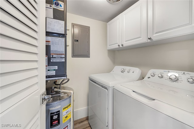 washroom featuring cabinets, washing machine and dryer, electric water heater, electric panel, and wood-type flooring