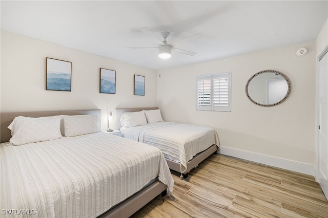 bedroom with ceiling fan and light hardwood / wood-style flooring