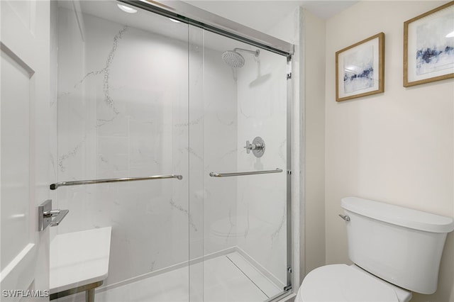 bathroom with toilet, a shower with shower door, and sink