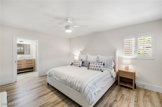 bedroom featuring ensuite bathroom, ceiling fan, light hardwood / wood-style floors, and sink