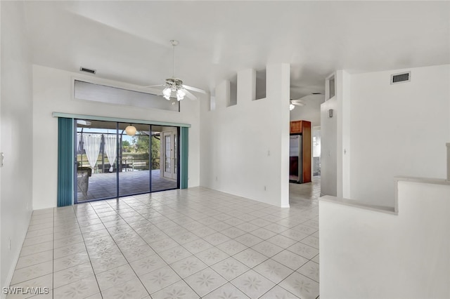 empty room featuring light tile patterned floors and ceiling fan