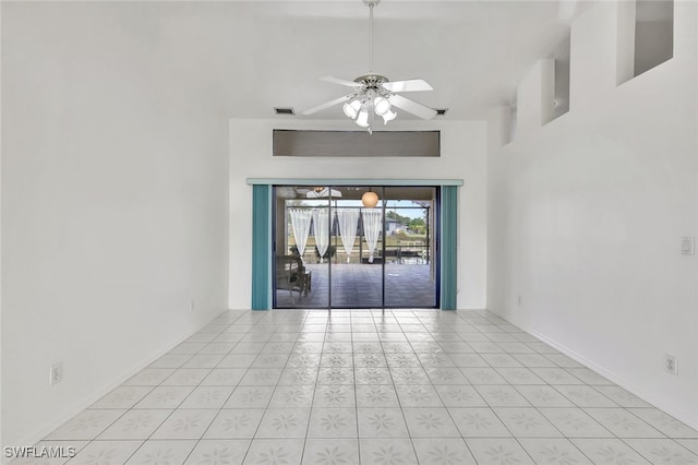 spare room featuring light tile patterned floors and ceiling fan