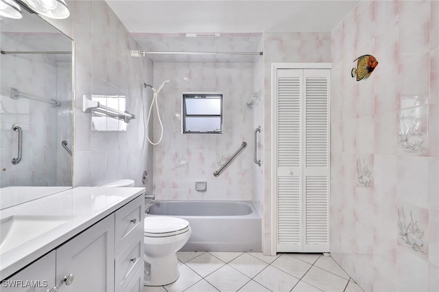 bathroom featuring tile patterned flooring, vanity, tile walls, and toilet