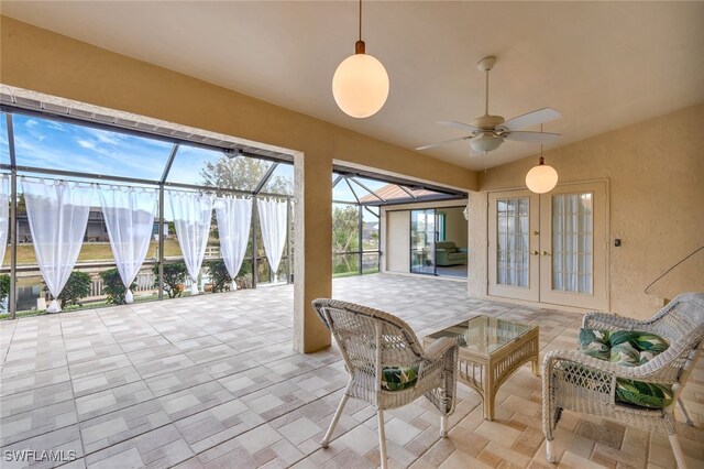 sunroom / solarium featuring ceiling fan and french doors