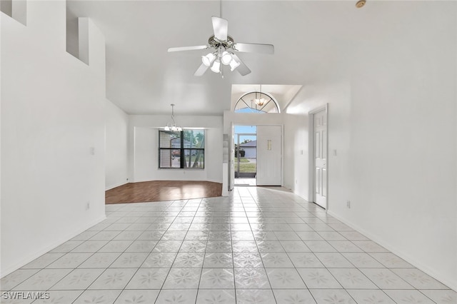 interior space featuring ceiling fan with notable chandelier