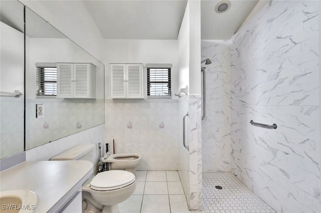 bathroom with a bidet, tile walls, tiled shower, vanity, and toilet