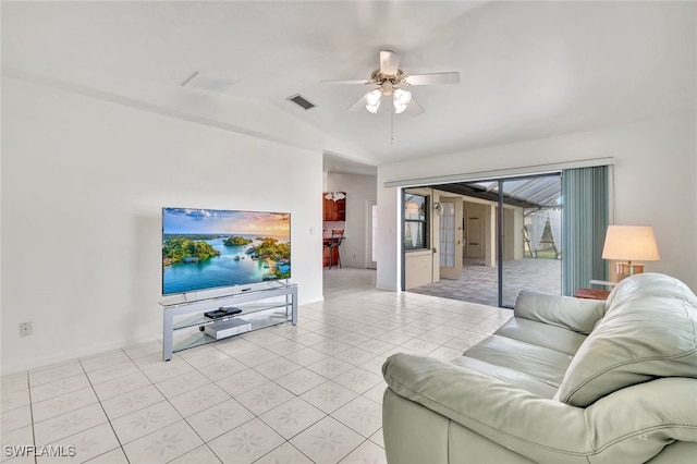 living room with vaulted ceiling, ceiling fan, and light tile patterned flooring