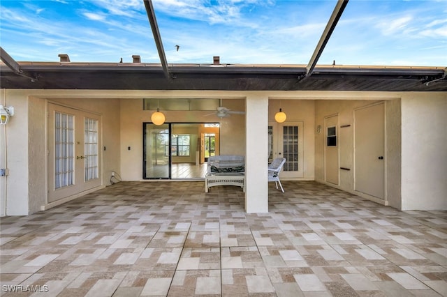 view of patio / terrace featuring french doors, ceiling fan, and glass enclosure