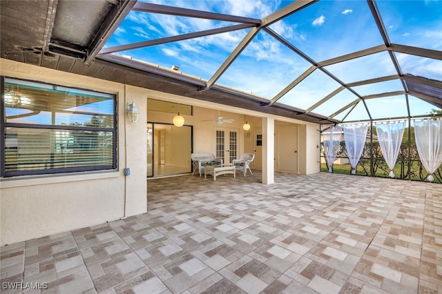 view of patio with french doors, ceiling fan, and glass enclosure