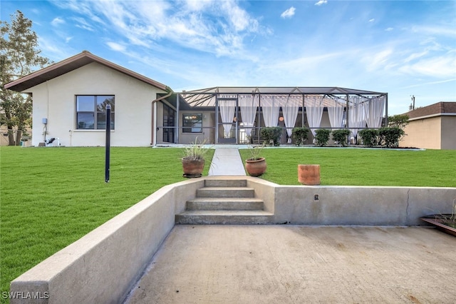 view of front of home with glass enclosure and a front lawn