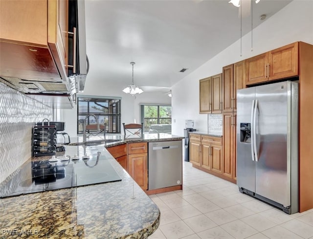 kitchen with vaulted ceiling, appliances with stainless steel finishes, stone countertops, pendant lighting, and sink