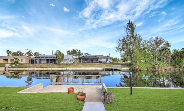 view of dock with a water view and a lawn