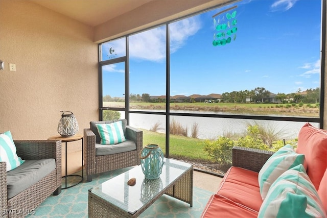 sunroom / solarium featuring a water view