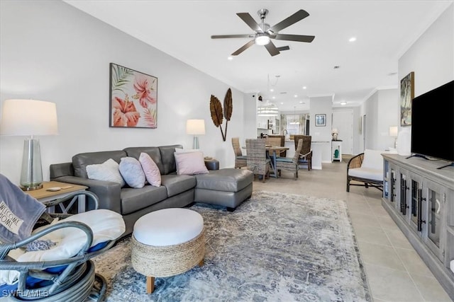 living room with light tile patterned flooring, ceiling fan, and ornamental molding