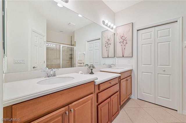 bathroom with vanity, tile patterned floors, and a shower with shower door