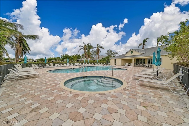 view of pool featuring a patio and a hot tub