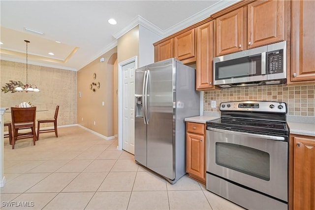 kitchen with backsplash, ornamental molding, stainless steel appliances, a chandelier, and hanging light fixtures