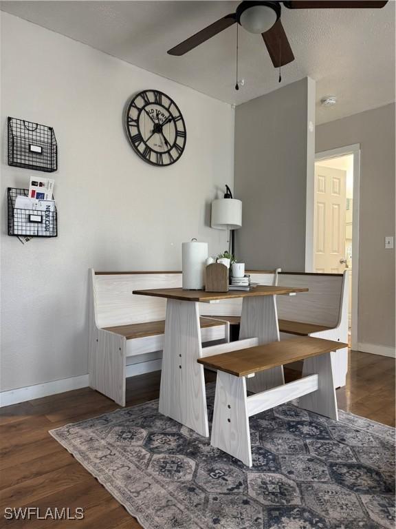 dining area featuring ceiling fan and dark hardwood / wood-style flooring