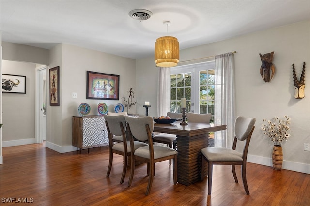 dining area with dark wood-type flooring