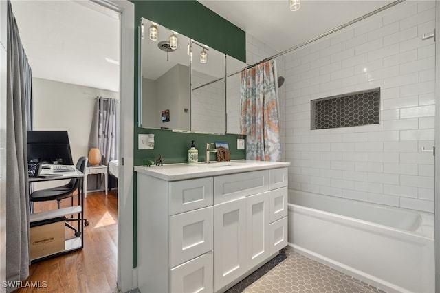 bathroom featuring wood-type flooring, vanity, and shower / bath combo