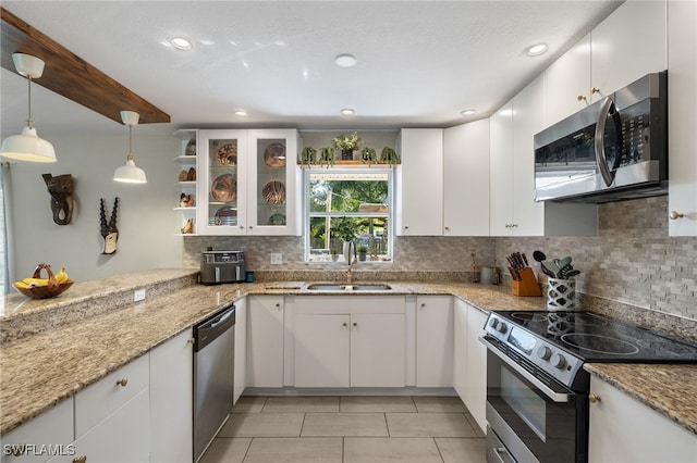 kitchen featuring sink, white cabinetry, hanging light fixtures, and stainless steel appliances