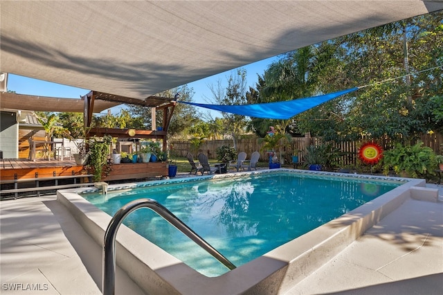 view of swimming pool featuring a deck