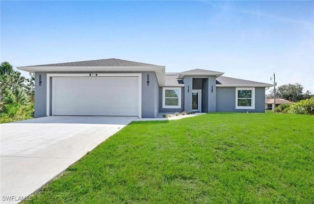 view of front of house with a garage and a front yard