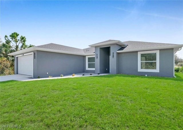 view of front of home with a front yard and a garage