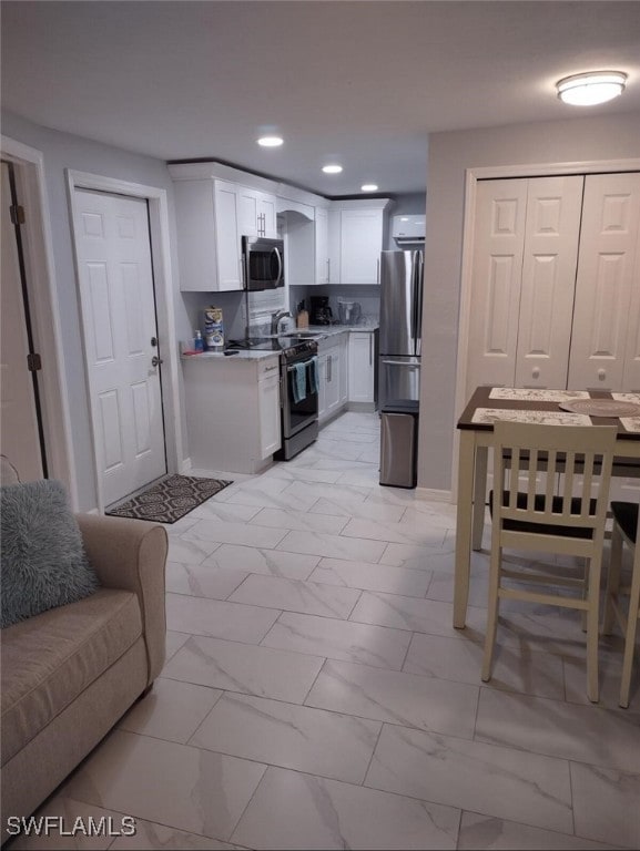 kitchen featuring appliances with stainless steel finishes and white cabinetry