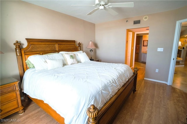 bedroom with dark hardwood / wood-style flooring and ceiling fan