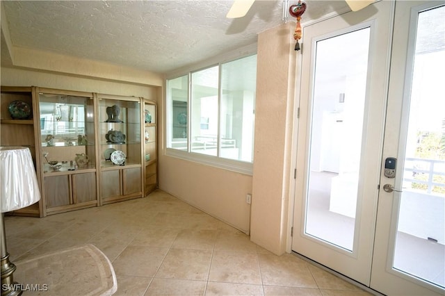 interior space with ceiling fan, a healthy amount of sunlight, and french doors