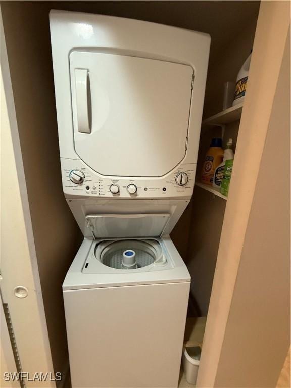 laundry area with stacked washer / dryer