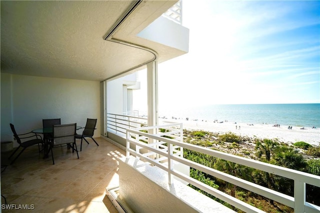 balcony with a beach view and a water view