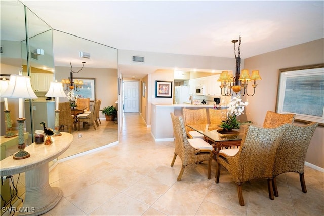 tiled dining area featuring an inviting chandelier