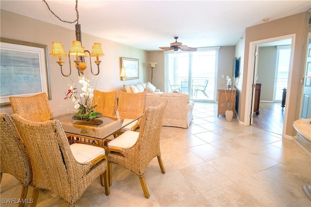 dining room with light tile patterned floors and ceiling fan with notable chandelier