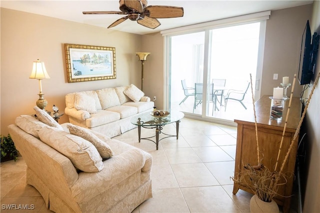 tiled living room with floor to ceiling windows and ceiling fan