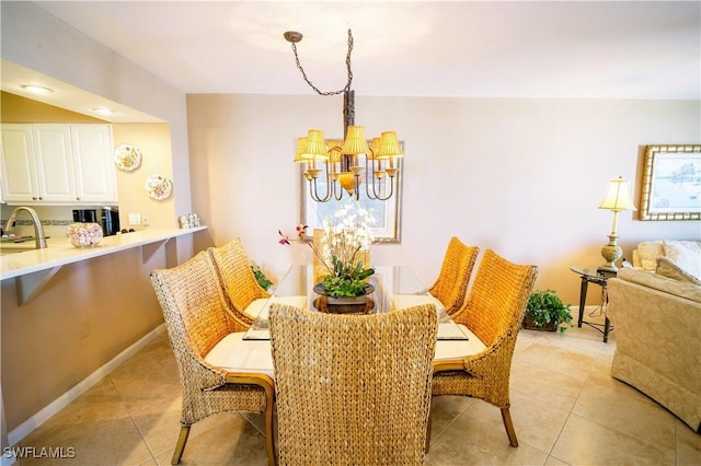 tiled dining area with sink and a chandelier