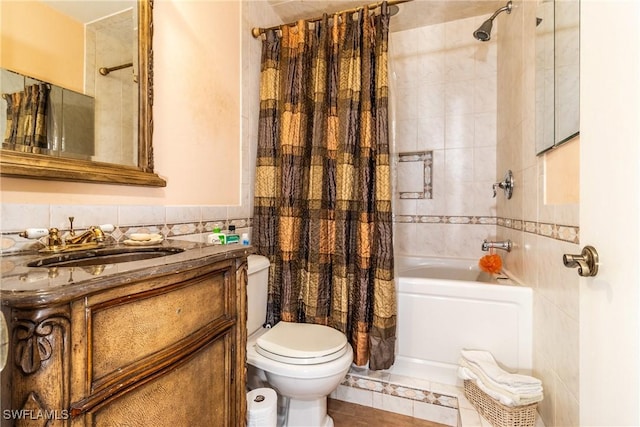 full bathroom featuring shower / tub combo with curtain, tile walls, toilet, vanity, and tile patterned flooring