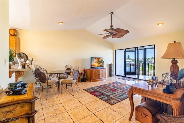 tiled living room featuring ceiling fan and vaulted ceiling