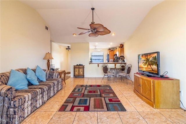 living room featuring light tile patterned floors, ceiling fan, and lofted ceiling