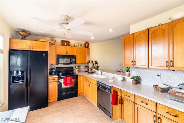 kitchen with black appliances, tasteful backsplash, light countertops, and a sink