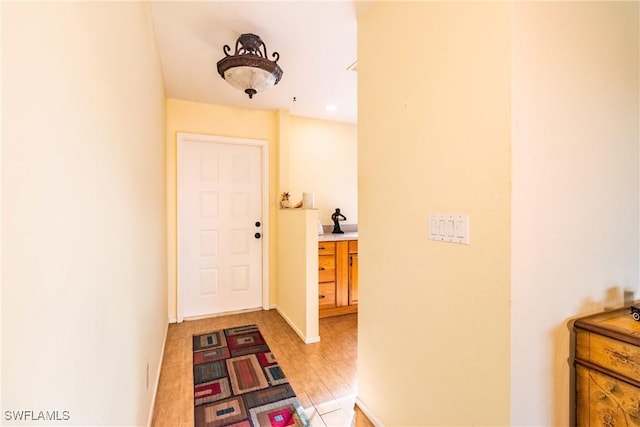 interior space featuring baseboards and light wood-style floors