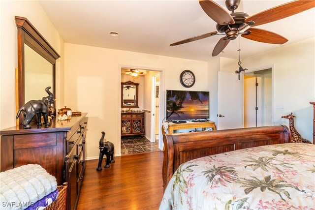 bedroom featuring connected bathroom, dark hardwood / wood-style floors, and ceiling fan