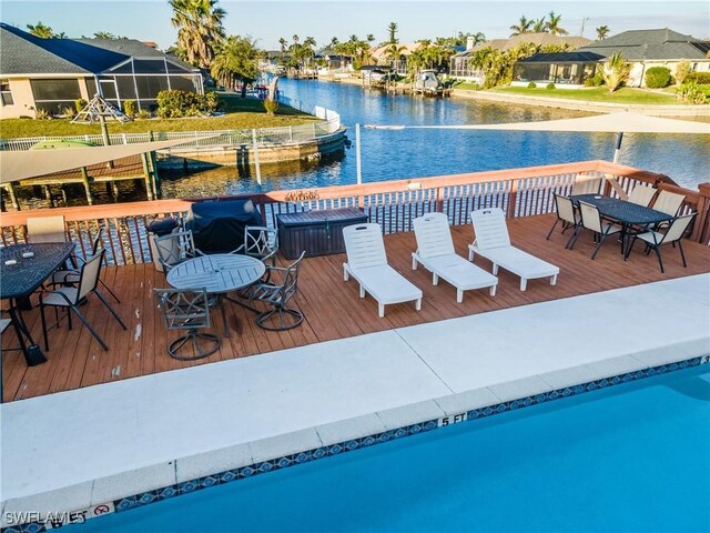 view of dock with a deck with water view