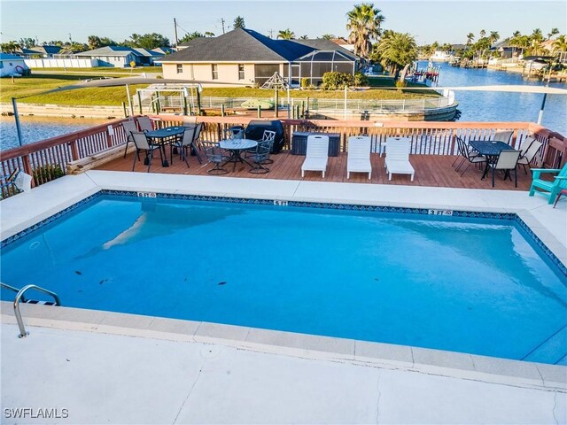 view of pool with a deck with water view