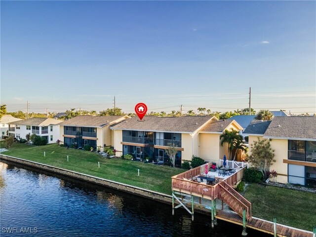 rear view of property with a water view